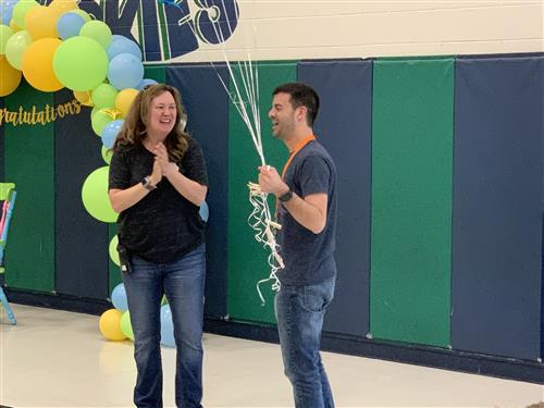 Mrs Archer surprising Michael Leali with balloons