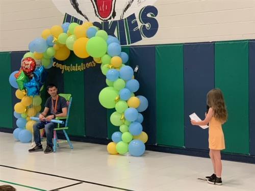 Student reading a letter to Michael Leali