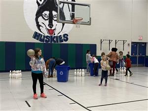Mrs. Curran's class playing bowling games at the winter party