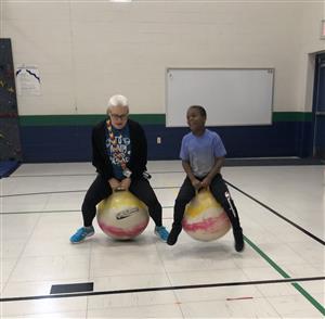 Mrs. Walters and a STARS student doing the obstacle course