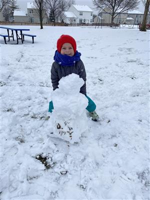 Kindergarten student making a snowman