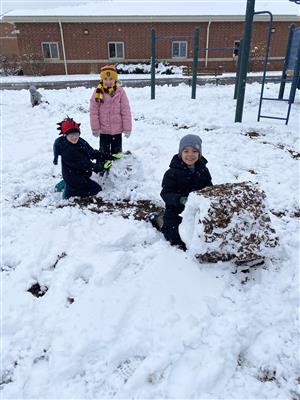 Kindergarten students playing in the snow
