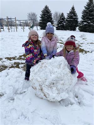 Kindergarten students making a snowman