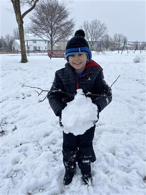 Kindergarten student making a snowman