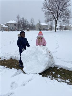 Students rolling a snow ball
