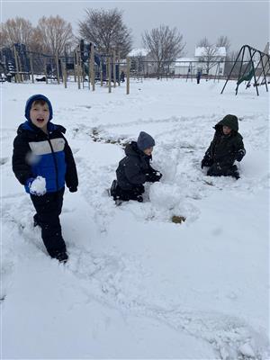 Students making a snowman