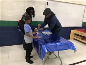 STARS students and his parents making a craft