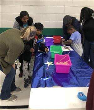 Staff and STARS students making crafts