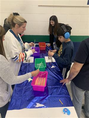 Staff and students making crafts at STARS family night