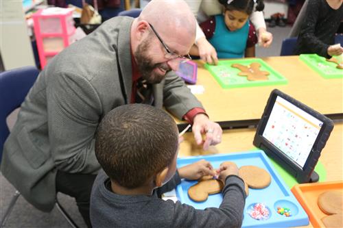 Dr. Sparlin with Student making gingerbread boy