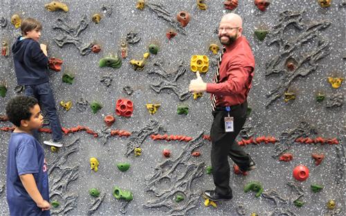 Dr. Sparlin and students on rock climbing wall