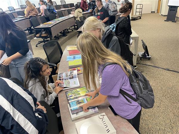 Editors of the 2023 OHS Yearbook collaborate on graphic design.