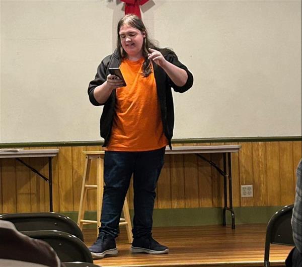 OHS junior Ryker Stevenson presents a Spoken Word piece at the Oswego Little White Schoolhouse on Tuesday, December 13, 2022.