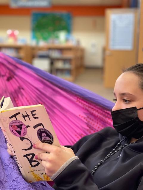 Freshman Maddie Mundsinger reads the 2021-2022 One Book One School title, The 57 Bus, during the February 8th Day of Reading in the LRC.