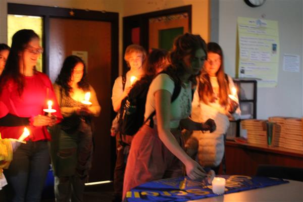 42Fifty staff member Natalie Raabe lights her own candle from the 