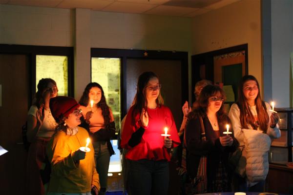 Pictured from left to right are Quill & Scroll initiates Avery Schlesinger, Gianna King, Liliana Murillo, Jessica Taylor, Shaelyn Benson, and Brooke Amelio.  Initiates lit candles from the \