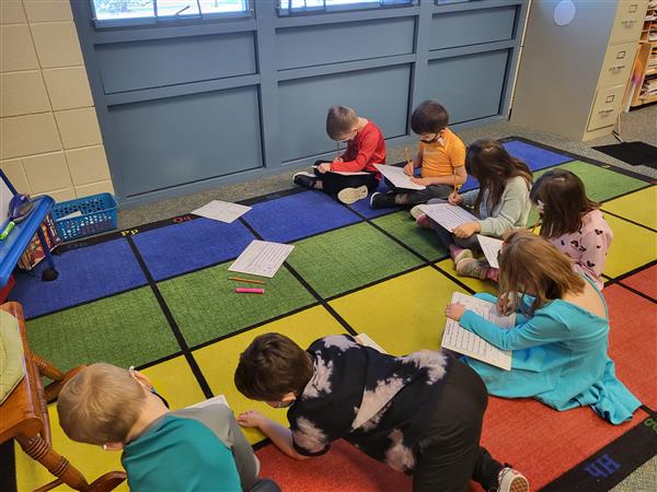 Mrs. Tellone's kindergarten class in in small groups for ELA