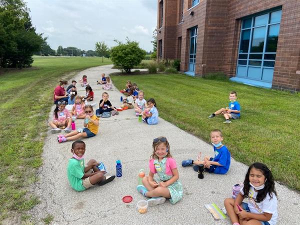Mrs. McCoskey's Kindergarten enjoying snack time outside