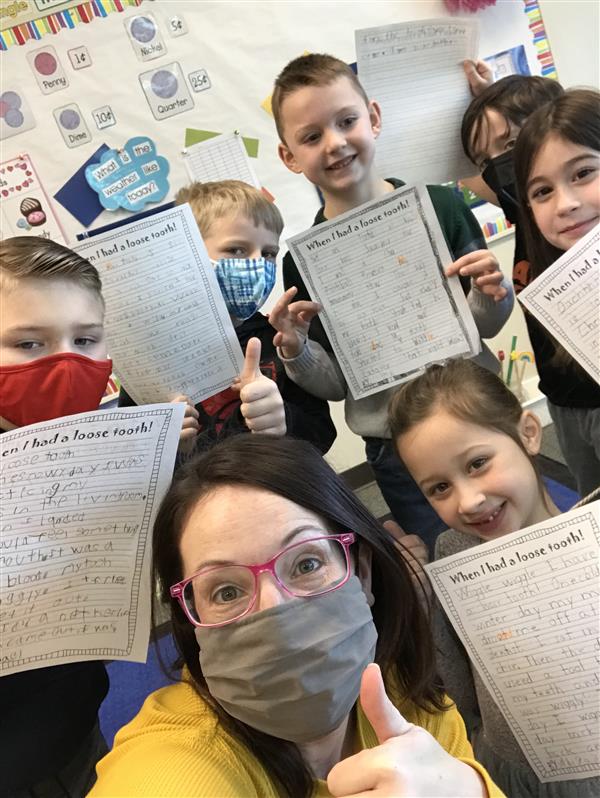 Mrs. Brougham's 1st grade sharing their writing with their kindergarten teacher and her class