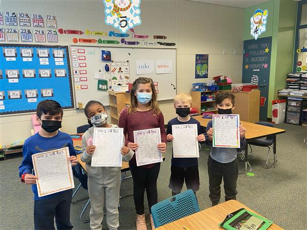 Mrs. Brougham's students sharing their writing with Mrs. McCoskey's kindergarten class.