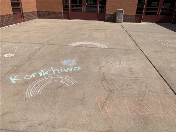 Messages written in chalk on the sidewalk