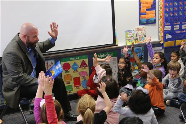 Dr. Sparlin looks on as student and teacher work on story creating