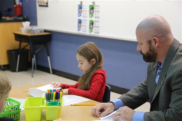 Dr. Sparlin making aliens in art class with 1st grade students at TW