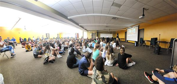 Group of Murphy Jr. High 6th graders sit and listen to author presentation