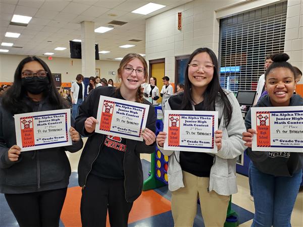 Students pose with certificates at math competition