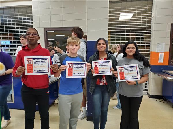 Students pose with certificates at math competition