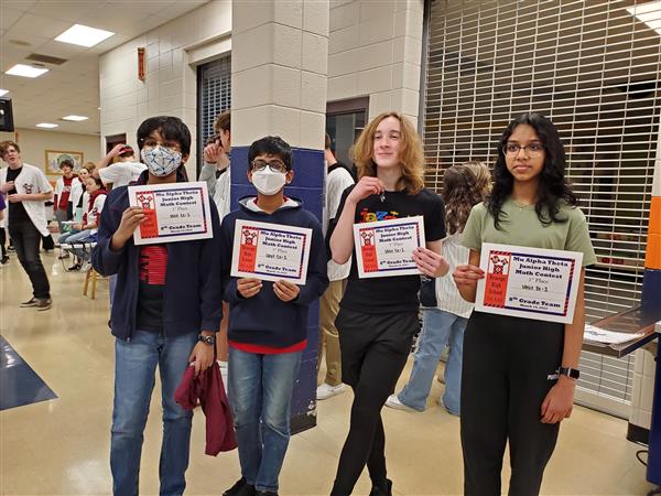 Students pose with certificates at math competition