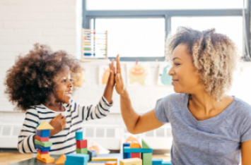 girl and teacher high fiving