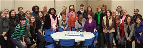 Teachers by a cake. 