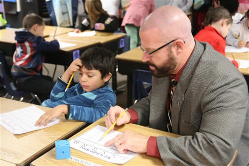 Dr. Sparlin and student playing sight word dice activity