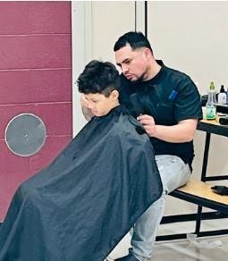 student receiving haircut