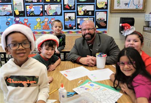 Dr. Sparlin with students in art class at a different table