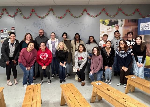 Osewgo High School National English Honor Society members joined with WEClub to serve at Feed My Starving Children in Naperville, IL. Together, these clubs helped to package food items for children in countries plagued by starvation.